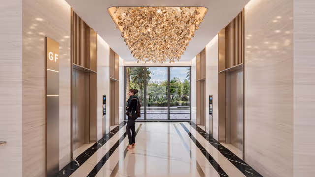 Aspirz – ground-floor lift lobby with sculptural ceiling light