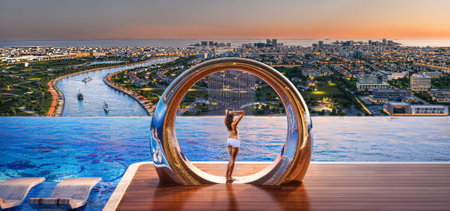 Bayz 102 – sculptural rain-shower ring on the pool deck above the canal