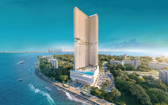 Breez by Danube – aerial view of the 60-floor oceanfront tower with the Downtown Dubai skyline behind