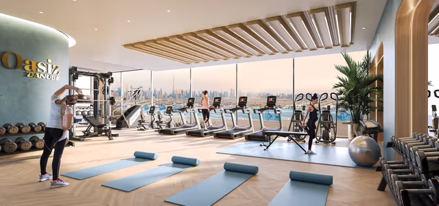 Oasiz 2 by Danube – indoor gym with cardio line facing the skyline and podium pool