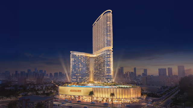 Serenz by Danube – 50-storey tower and podium retail illuminated at night