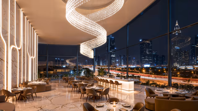 Shahrukhz by Danube – lounge and dining space with spiral chandelier facing Sheikh Zayed Road