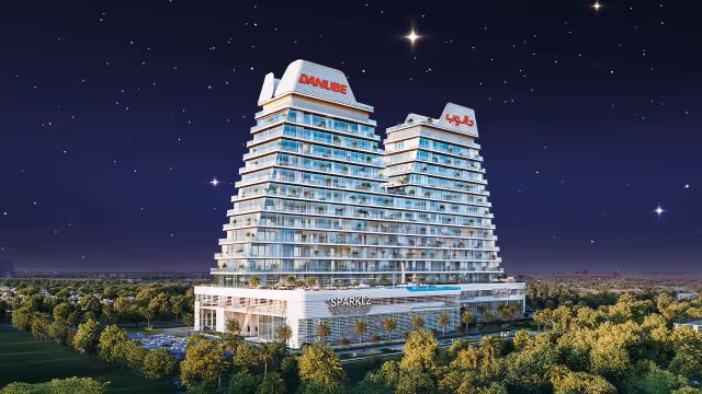 Sparklz by Danube – full elevation of both towers above the Sparklz retail podium at night